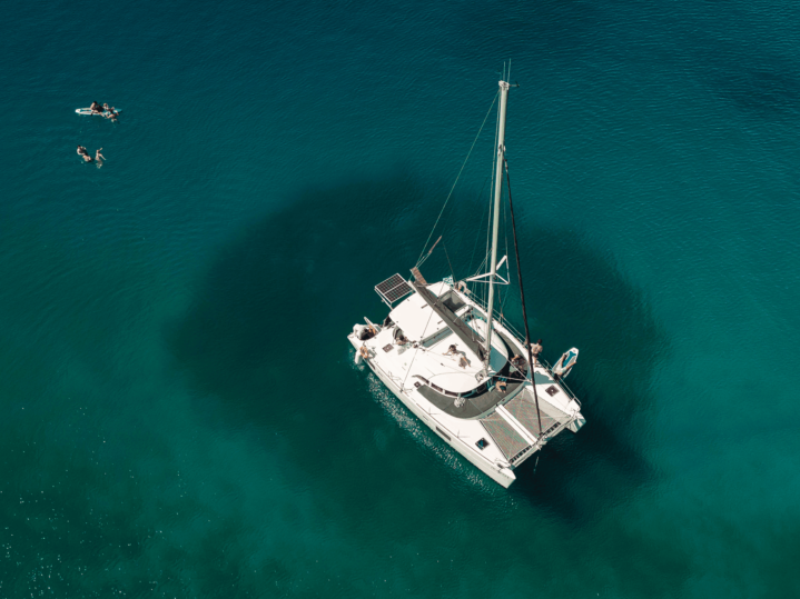 Luxury catamaran sailing in Nafplio with guests relaxing on deck during a full-day cruise